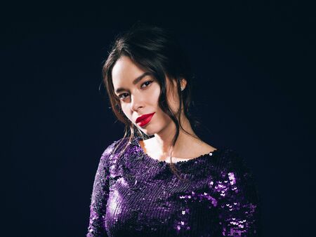 Woman in sequin dress night club concept red lips asian beauty. Studio shot.の写真素材