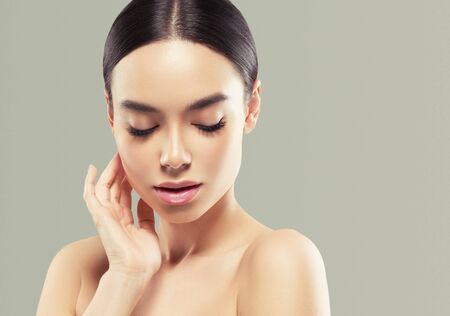 Asia beauty woman  with closed eyes healthy skin face clean fresh skin spa. Studio shot. Color background.の写真素材