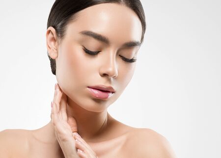 Asia beauty woman  with closed eyes healthy skin face clean fresh skin spa. Studio shot.  Isolated on white.の写真素材