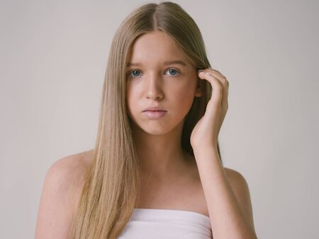 Long smooth hair clean skin girl healthy skin care natural makeup female portrait isolated on white. Studio shot.の写真素材