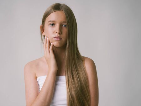 Long smooth hair clean skin girl healthy skin care natural makeup female portrait isolated on white. Studio shot.の写真素材
