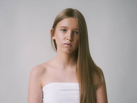 Long smooth hair clean skin girl healthy skin care natural makeup female portrait isolated on white. Studio shot.の写真素材