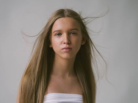 Long smooth hair clean skin girl healthy skin care natural makeup female portrait isolated on white. Studio shot.の写真素材