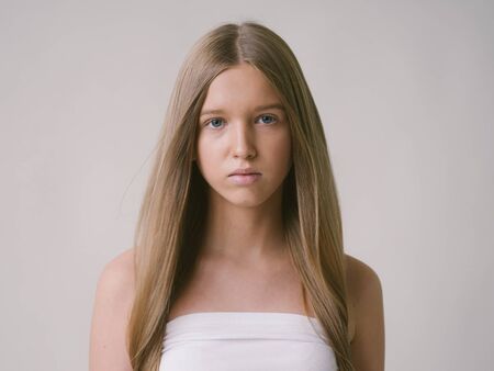 Long smooth hair clean skin girl healthy skin care natural makeup female portrait isolated on white. Studio shot.の写真素材