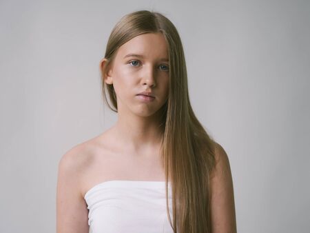 Long smooth hair clean skin girl healthy skin care natural makeup female portrait isolated on white. Studio shot.の写真素材