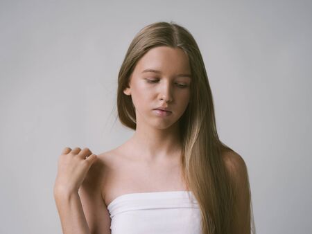 Long smooth hair clean skin girl healthy skin care natural makeup female portrait isolated on white. Studio shot.の写真素材