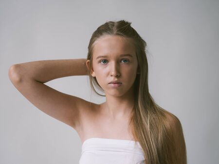 Long smooth hair clean skin girl healthy skin care natural makeup female portrait isolated on white. Studio shot.の写真素材