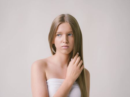 Long smooth hair clean skin girl healthy skin care natural makeup female portrait isolated on white. Studio shot.の写真素材