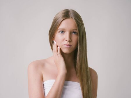Long smooth hair clean skin girl healthy skin care natural makeup female portrait isolated on white. Studio shot.の写真素材