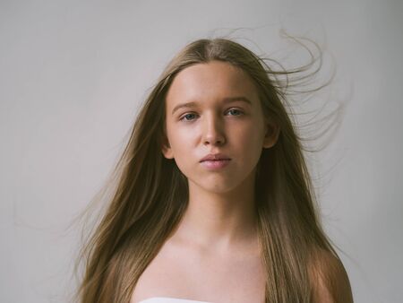 Long smooth hair clean skin girl healthy skin care natural makeup female portrait isolated on white. Studio shot.の写真素材