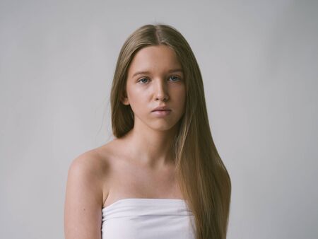 Long smooth hair clean skin girl healthy skin care natural makeup female portrait isolated on white. Studio shot.の写真素材
