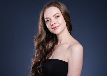 Beauty hair woman curly hairstyle natural makeup. Studio shot.の写真素材