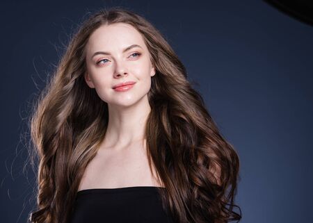 Beauty hair woman curly hairstyle natural makeup. Studio shot.の写真素材