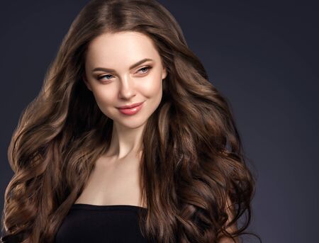 Beauty hair woman curly hairstyle natural makeup. Studio shot.の写真素材