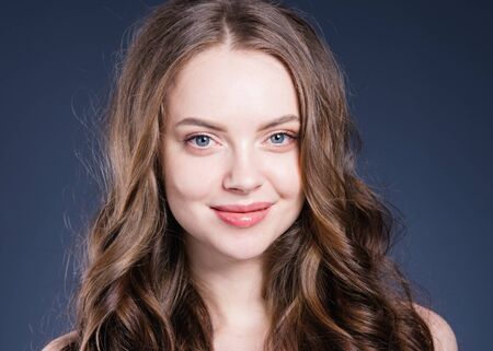 Beauty hair woman curly hairstyle natural makeup. Studio shot.の写真素材