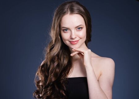 Beauty hair woman curly hairstyle natural makeup. Studio shot.の写真素材