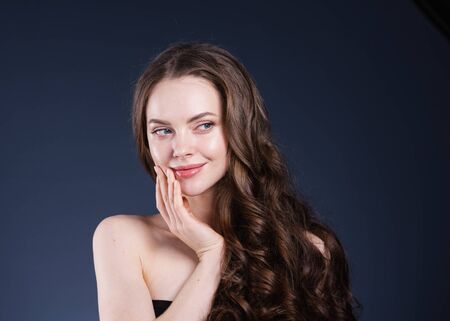 Beauty hair woman curly hairstyle natural makeup. Studio shot.の写真素材