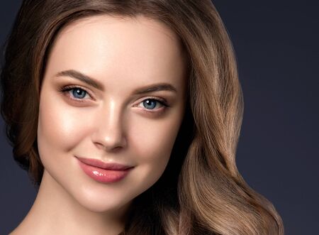 Beauty hair woman curly hairstyle natural makeup. Studio shot.の写真素材