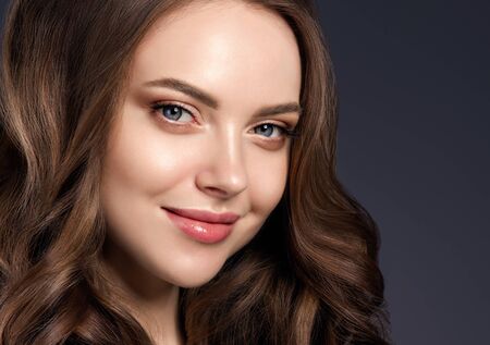 Beauty hair woman curly hairstyle natural makeup. Studio shot.の写真素材