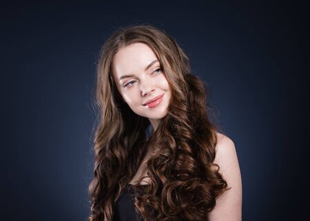 Beauty hair woman curly hairstyle natural makeup. Studio shot.の写真素材
