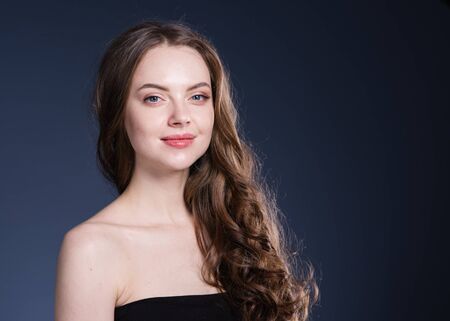 Beauty hair woman curly hairstyle natural makeup. Studio shot.の写真素材
