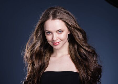 Beauty hair woman curly hairstyle natural makeup. Studio shot.の写真素材