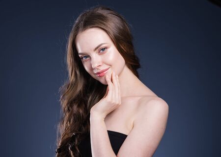 Beauty hair woman curly hairstyle natural makeup. Studio shot.の写真素材