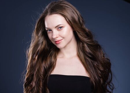 Beauty hair woman curly hairstyle natural makeup. Studio shot.の写真素材