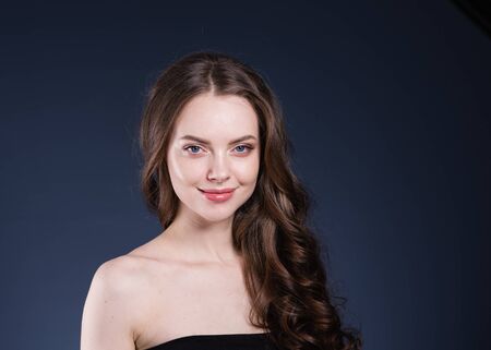 Beauty hair woman curly hairstyle natural makeup. Studio shot.の写真素材