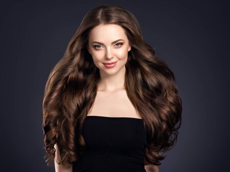 Beauty hair woman curly hairstyle natural makeup. Studio shot.の写真素材