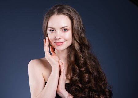 Beauty hair woman curly hairstyle natural makeup. Studio shot.の写真素材