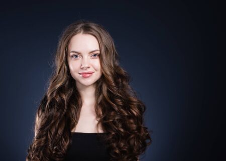 Beauty hair woman curly hairstyle natural makeup. Studio shot.の写真素材