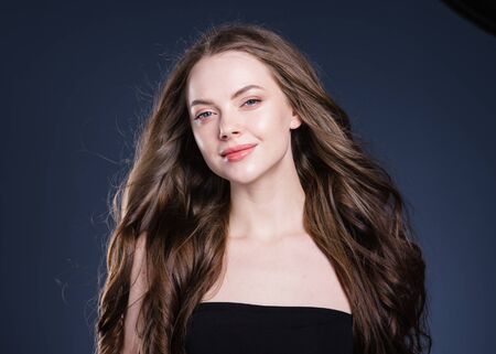 Beauty hair woman curly hairstyle natural makeup. Studio shot.の写真素材
