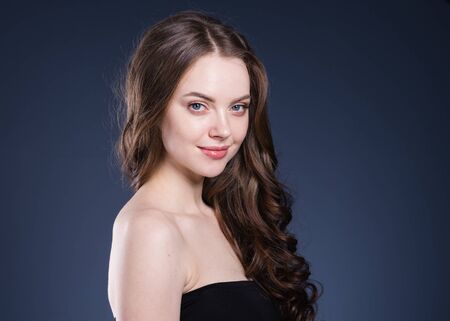 Beauty hair woman curly hairstyle natural makeup. Studio shot.の写真素材