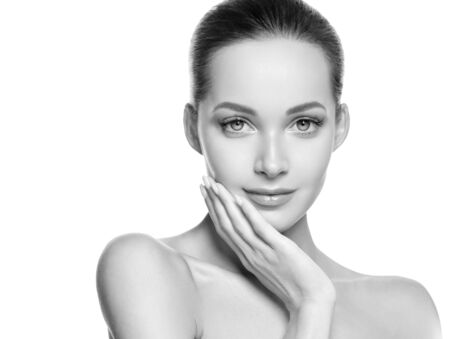 Woman beauty face healthy skin natural makeup beautiful young model. Studio shot. Monochrome. Gray. Black and white.の写真素材