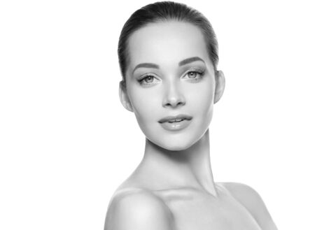 Woman beauty face healthy skin natural makeup beautiful young model. Studio shot. Monochrome. Gray. Black and white.の写真素材