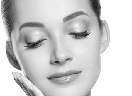 Woman beauty face healthy skin natural makeup beautiful young model. Studio shot. Monochrome. Gray. Black and white.の写真素材