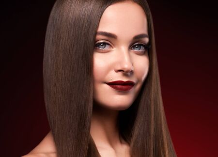 Beautiful hair woman long smooth brunette hairstyle beauty healthy hair female model portrait.  Studio shot.の写真素材