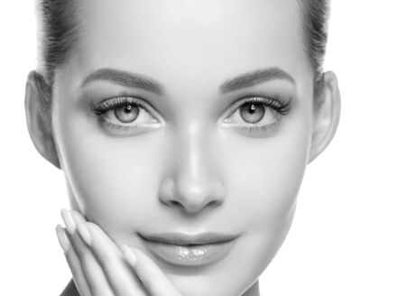 Woman beauty face healthy skin natural makeup beautiful young model. Studio shot. Monochrome. Gray. Black and white.の写真素材