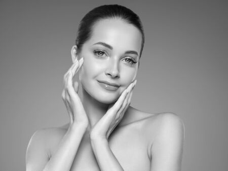 Skin care woman beauty face healthy face skin cosmetic model emotional andhappy. Studio shot.  Monochrome. Gray. Black and white.の写真素材