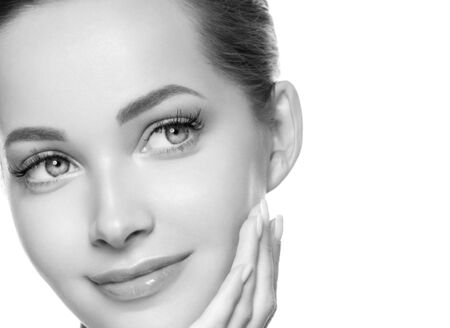 Woman beauty face healthy skin natural makeup beautiful young model. Studio shot. Monochrome. Gray. Black and white.の写真素材