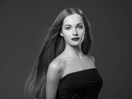 Beautiful hair woman healthy beauty hairstyle model. Studio shot. Monochrome. Gray. Black and white.の写真素材
