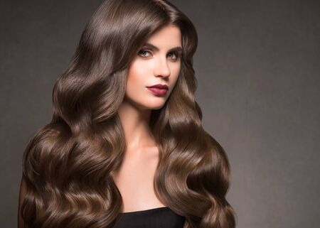 Hairte hairstyle model beauty woman long curly brunat. Studio shot.の写真素材