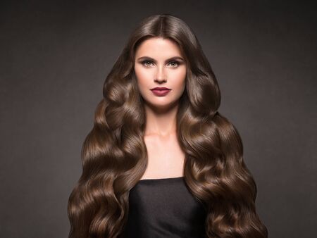Hairte hairstyle model beauty woman long curly brunat. Studio shot.の写真素材