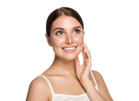 Healthy teeth smile woman clean skin natural makeup female portrait over gray background. Studio shot.の写真素材