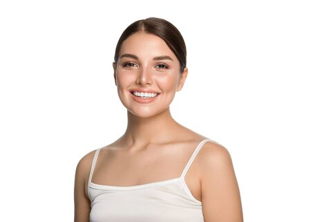 Healthy teeth smile woman clean skin natural makeup female portrait over gray background. Studio shot.の写真素材