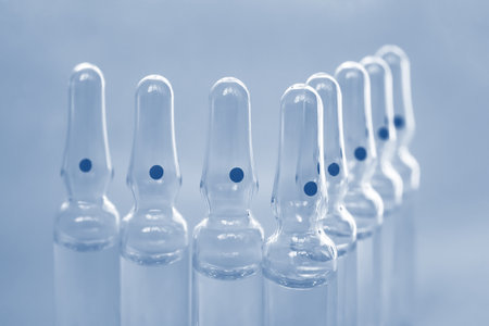 Glass ampoules close up. Medical ampoules. Medical ampoules on a blue background. Vaccination...