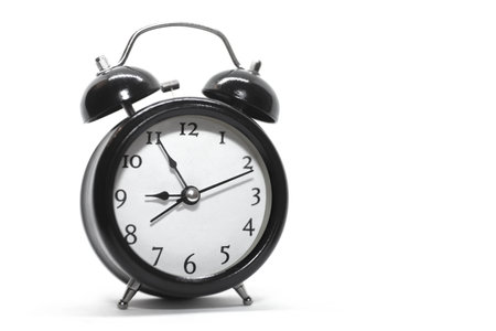 Black retro alarm clock isolated on white background. Reminder. Time conceptの写真素材