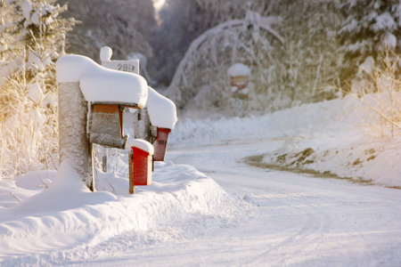 mailboxes in snow stand along a country road in Finlandの写真素材