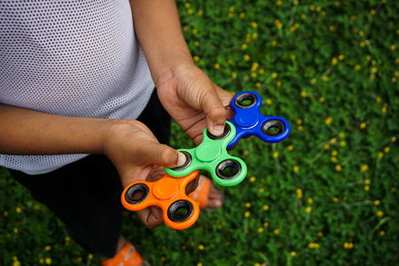 Young boy play with fidget spinner stress relieving toy